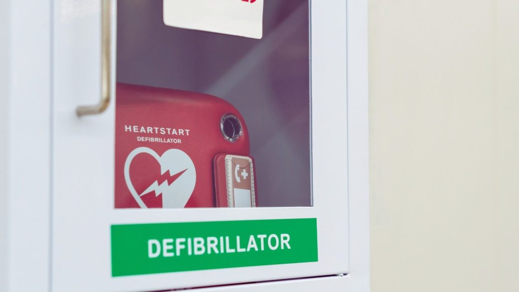 Public defibrillator highlighting the cardiac arrest risk of Sudden Sniffing Death Syndrome.
