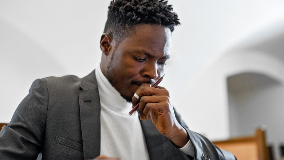 Alcoholic vs Addict Is There a Difference hero image of a man considering the difference.