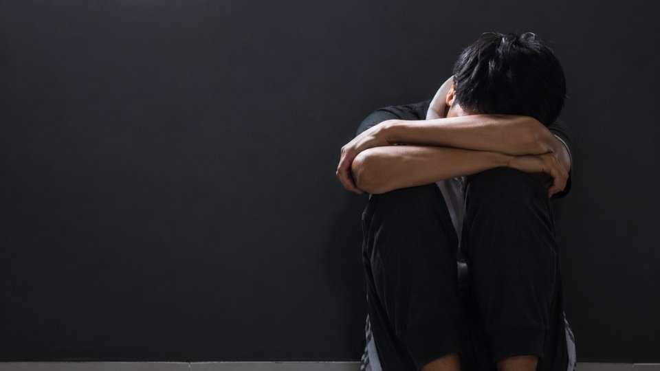 Greened Out hero image of a man who has taken too much THC, and crouches down.