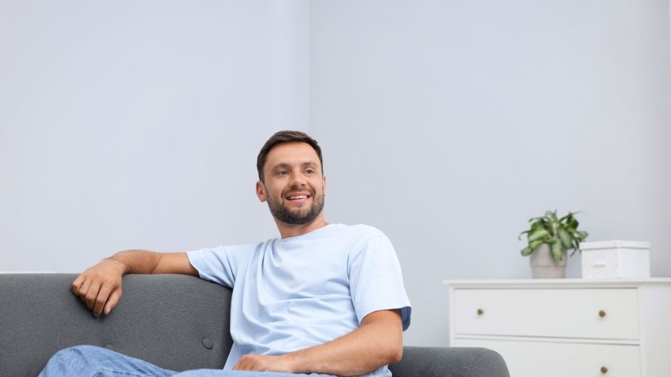 Suboxone vs Methadone How do MAT Options Compare hero image of a man on a couch meeting with his addiction care team.